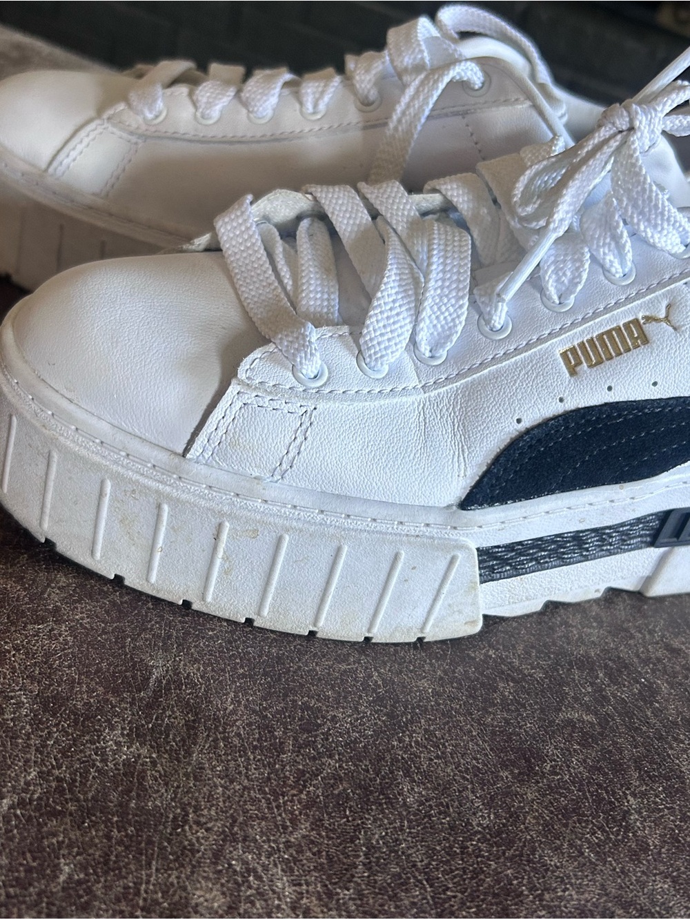 Puma women’s White Sneakers with Black Side Stripe and Gold Logo